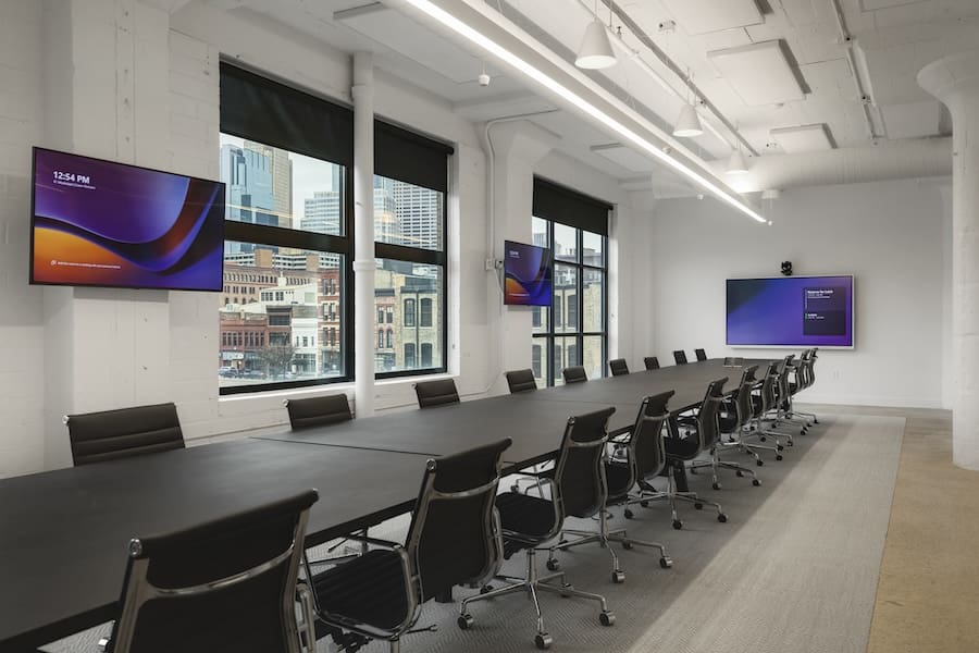 Large conference room with meeting table and colorful presentation displays around the room.